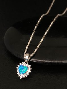 "Dainty Blue Fire Opal Heart Necklace Arr Deco Sterling Silver Blue Opal Pendant, Something Blue Necklace NECKLACE FEATURES: Metal: All components are made from solid .925 Sterling Silver Model is wearing 16\" in length solid .925 Sterling Silver Chain Length available: 16\", 18\" or 20\" Stone: Lab-created Blue Opal Pendant Measurements: Height: 16mm (0.63\") including bail Width: 10mm (0.39\") Your Blue Opal Necklace will arrive in a gift box, beautifully wrapped and ready for gifting Please s Blue Cubic Zirconia Heart Cut Necklace, Blue Heart Cut Cubic Zirconia Necklace, Elegant Blue Heart Necklace For Wedding, Heart Pendant Rhinestone Necklace For Wedding, Blue Heart Necklace With Heart Charm For Wedding, Blue Heart Charm Necklace For Wedding, Wedding Necklace With Heart Pendant Rhinestones, Wedding Heart Pendant Necklace With Rhinestones, Blue Heart Cut Necklace For Wedding