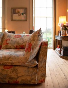 a living room filled with furniture and windows