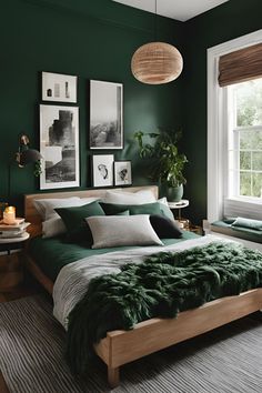 a bedroom with green walls and bedding in front of a large window that has pictures on the wall