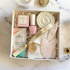 an open box with various items in it on a marble countertop next to a cup and saucer