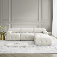 a white couch sitting on top of a wooden floor