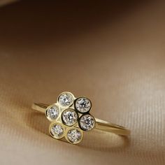 a gold ring with three diamonds on it