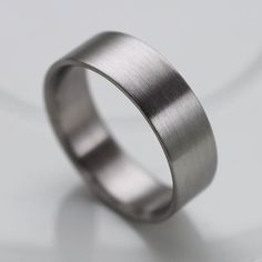 a wedding ring is shown on a white surface