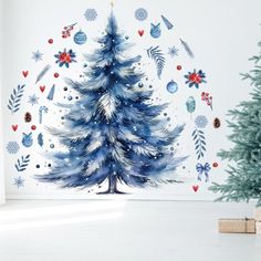 a blue christmas tree with snowflakes and stars on the wall next to it