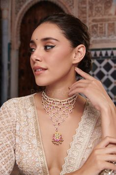 Elegance dances upon your neck as you adorn yourself with the ethereal beauty of our favorite Pink Kundan Choker Necklace. This Indian kundan necklace weaves a tapestry of opulence, while pink teardrop kundan units twinkle like distant stars, cascading down the intricate strands. The Bridal choker necklace consists of a pink floral-moon motif pendant, exuding a captivating charm. Each element harmonizes, reflecting the grace of a moonlit night, and whispers tales of grace with a touch of whimsical romance. Closure - Lobster Handcrafted in Jammu and Kashmir Paisley Pop travels the depths of India to learn techniques and crafts from deep down in the local markets and villages. We give utmost importance to our quality and packaging. Our goal is to make sure you receive exactly what you are lo Elegant Kundan Necklace With Pallu For Rituals, Elegant Temple Necklace With Latkans For Party, Elegant Party Temple Necklace With Latkans, Fusion Style Bridal Necklace With Tilla For Party, Festive Temple Necklace For Reception, Festive Temple Necklace For Receptions, Elegant Choker For Rituals And Festivals, Indian Bridal Necklace, Bridal Choker Necklace