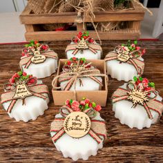 soaps decorated with ribbons and bows are sitting on a table next to some boxes