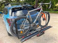 a bike is strapped to the back of a car