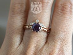 a woman's hand with a ring on it that has an oval shaped blue stone