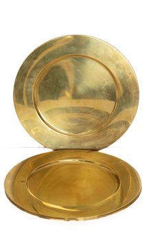 two gold plates sitting on top of each other