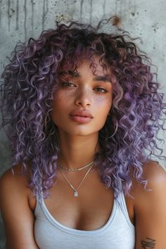 Soft lavender balayage on curly hair emphasizes natural textures with a vibrant pop of color, highlighting the beauty of curls with a whimsical twist. Purple Balayage Curly Hair Natural Curls, Curly Hair Fashion Color, Lavender Curly Hair Black Women, Vibrant Curly Hair Color, Color Black Curly Hair, Natural Texture Hair, Curly Hair Two Colors, Fashion Color Curly Hair, Ombré Hair Curly