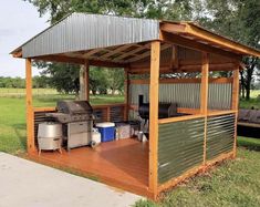 an outdoor bbq with grills and picnic tables