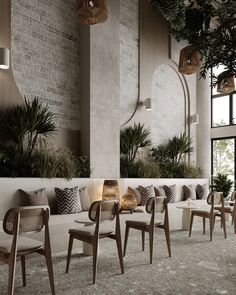 an indoor seating area with chairs and plants