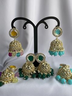 - [ELEGANT DESIGN] The jhumkas are designed to add a touch of traditional elegance to any outfit. - [VERSATILE STYLE] These earrings can be paired with a variety of ethnic wear outfits for a stunning look. - [HIGH QUALITY MATERIAL] Made with high-quality materials to ensure durability and longevity. Green Stone Work Jhumkas For Celebration, Multicolor Kundan Jhumkas With Cutdana, Festive Multicolor Chandbali Jhumkas, Heavy Multicolor Jhumkas For Celebration, Multicolor Jhumkas For Navratri Festival, Multicolor Chandbali Jhumkas For Festive Occasions, Multicolor Stone Work Jhumkas For Wedding, Multicolor Cutdana Jhumkas For Diwali, Festive Green Stone Work Jhumkas