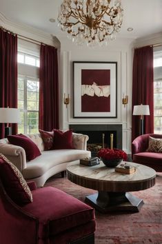 a living room filled with furniture and a chandelier hanging from the ceiling over a fire place