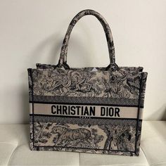 Shop With Confidence! We Only Sell Authentic!!! Brand: Christian Dior Made In Italy Style/Size/Color: Tote Bag/ Approx. 14" W X 10.50" H X 4.5" Dx Handle Drop: 6.5"/Navy Blue Christian Dior Canvas Embroidered Dioriviera Toile De Jouy Book Tote Bag Blue And Ecru Toile De Jouy Reverse Embroidery Introduced By Maria Grazia Chiuri, Creative Director Of Christian Dior, The Dior Book Tote Has Become A Staple Of The Dior Aesthetic. Designed To Hold All The Daily Essentials, The Style Is Fully Embroidered With A Blue And Ecru Toile De Jouy Reverse Motif, A Variation Of The House's Hallmark Pattern With A Play On Reversed Colors. Adorned With The Christian Dior Paris Signatur Designer Embroidered Bags For Daily Use, Designer Embroidered Tote Bag, Designer Embroidered Shopping Bag, Designer Embroidered Bags For Shopping, Reverse Embroidery, Dior Aesthetic, Dior Book, Christian Dior Paris, Dior Paris