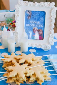 there are cookies on the table with toothpicks in front of them and a photo frame