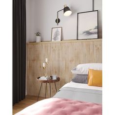 a bed room with a neatly made bed and two pictures on the wall above it