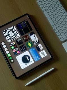 an ipad sitting on top of a wooden desk next to a keyboard