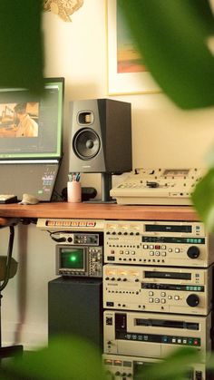 there is a computer on the desk with speakers and other equipment in front of it