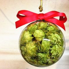 a glass ball ornament filled with green hops