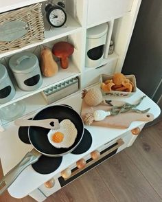 an image of kitchen utensils and food on the counter top in front of shelves