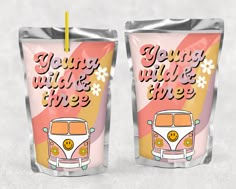 two plastic cups with the words young wild and three printed on them, sitting next to each other