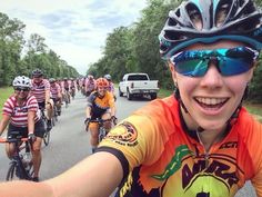 a group of people riding bikes down a road