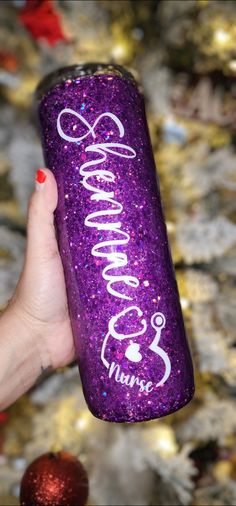 a hand holding a purple glittered can with the word grandma written on it