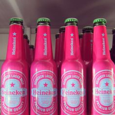 six pink heineken beer bottles lined up in a row