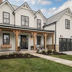 a large white house with black doors and windows