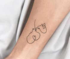 a woman's arm with a cat tattoo on it