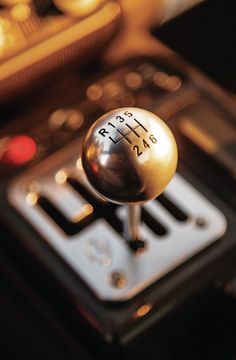 a close up view of a car's gear shift knob with the number plate and numbers on it