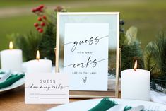 a table set with place cards, plates and candles for guests to sign in front of them