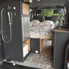 the back end of a van with its bed and kitchen area in it's trunk