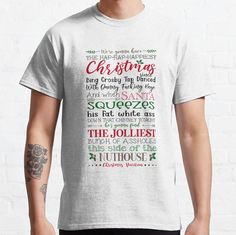 a man wearing a white t - shirt with the words christmas written in different languages