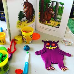 an open book and some toys on a table