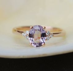 "This Engagement ring features a Lavender sapphire in oval cut. The sapphire is natural untreated, eye clean and sparkling. It is set in a 7-stone setting flanked by 6 diamonds. This ring would make a perfect engagement ring, anniversary ring or promise ring. The setting is 14k Rose gold, diamonds SI/H. Details: Center stone: Sapphire approx. 1.15ct (5x7mm)  natural, unheated, SI clarity Accented stone: Diamonds: SI/H, TDW 0.3ct This ring is ready to ship. We offer FREE SHIPPING Worldwide If you