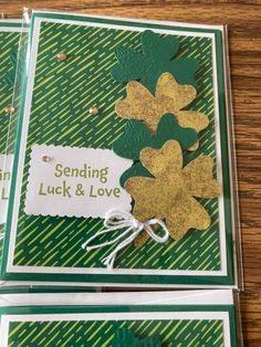 three cards with shamrocks on them, one is green and the other is gold