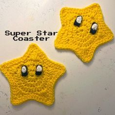 two crocheted yellow stars with black eyes and one has white eyeballs on it