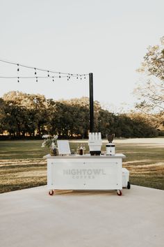 an outdoor ice cream cart with lights strung above it and the words nighttown coffee on top