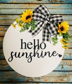 a sign that says hello sunshine with sunflowers in the center and black and white gingham ribbon