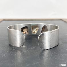 "This beautiful Modernist Scandinavian bracelet was made by Finnish studio Kasityo around 1960 and features three high relief polished quartz cabochons bezel set in 916 silver (Finnish standard). It's a really elegant piece and would look great in a stack! Measures 3/4\" width. Interior measurements 2 3/8 x 2\". Opening 5/8\" wide but this cuff is flexible and will stretch up to 1\". Stamped \"KASITYO\" with full Finnish hallmarks for 916 silver and 1962 date mark. Weighs 36.8 grams. In overall Contemporary Formal Bracelet With Oyster Design, Contemporary Polished Bangle Jewelry, Unique Cabochon Cuff Bangle Bracelet, Contemporary Polished Bangle, Contemporary Formal Oyster Bracelet, Modernist Polished Bangle Bracelets, Modernist Polished Cuff Bangle Bracelet, Modernist Polished Sterling Silver Bangle, Modernist Cuff Bracelet With Polished Finish