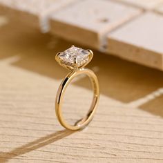 a diamond ring sitting on top of a wooden table