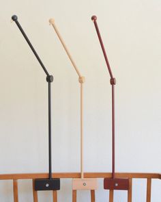 three wooden and metal items on display in a room