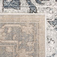 an area rug with blue and white designs on it