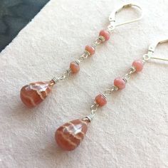 "I found some SUPER COOL Rhodocrosite recently and this is one of 3 pairs of these teardrops I purchased. I have wired them with faceted pink opals on sterling silver wire on sterling silver earrings. Sterling silver leverback earwires. The approximate length is 2 1/8\". Your jewelry will arrive beautifully giftboxed. Ships from NY USA." Stack Earrings, Basic French, Diy Jewelry Unique, Stacked Earrings, Wire Jewelry Designs, Rainbow Jewelry, Homemade Jewelry, Colorful Jewelry, Pink Earrings