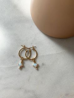 ❤︎ MATERIALS Hoops: 14k Gold Filled Ball Studs and Backing: 14k Gold Filled Charm: Opal / Cubic Zirconia ❤︎ SIZE Hoops: 14mm Ball Studs: 3mm Charm: 6mm x 9mm ❤︎ What is Gold Filled? My 14k Gold Filled hoops and stud earrings are manufactured in the U.S and consists of 5% (1/20) solid gold pressure bonded over brass. They are perfect for those with allergies or sensitive skin. Gold-filled jewelry has 100x more gold alloy than gold plated and because that layer is so much thicker, it means gold-fi Gold Huggie Earrings With Birthstone For Fine Jewelry, Gold Huggie Earrings With Birthstone, Gold Birthstone Huggie Earrings Fine Jewelry, Gold Hoop Earrings With Birthstone - Fine Jewelry, Gold Hoop Earrings With Birthstone, White 14k Gold Huggie Earrings As Gift, 14k Gold White Birthstone Earrings, White 14k Gold Birthstone Earrings, White Teardrop 14k Gold Hoop Earrings