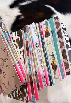 several notebooks are lined up in front of a cow