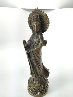 a bronze statue with a white background