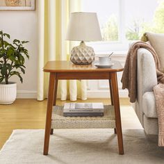 a living room scene with focus on the coffee table and sofa in the foreground